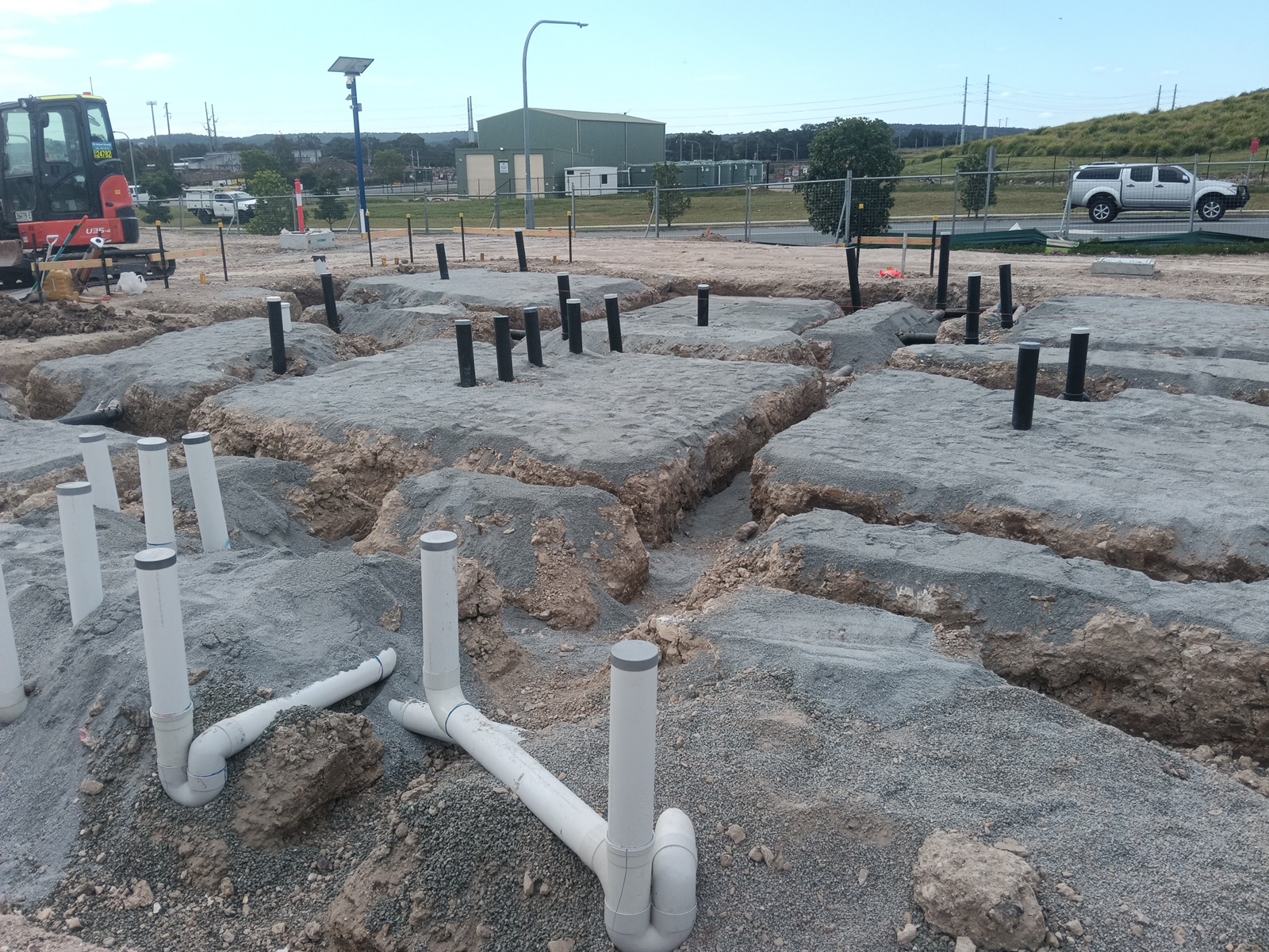Under-slab sanitary drainage installation on a commercial construction site